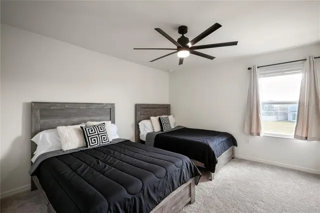 a bedroom with two beds and a window