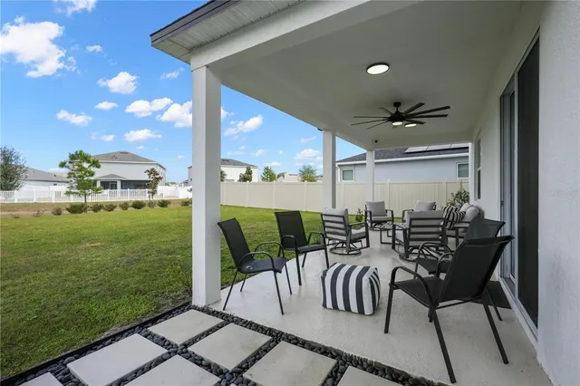 a view of a patio with table and chairs
