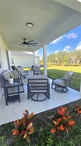 a living room with furniture and floor to ceiling window