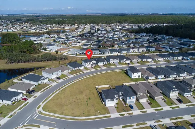 an aerial view of a house with a yard and sitting space