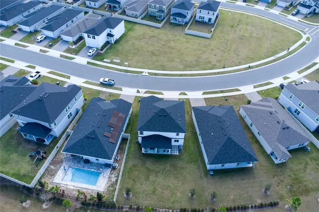 an aerial view of residential houses with outdoor space