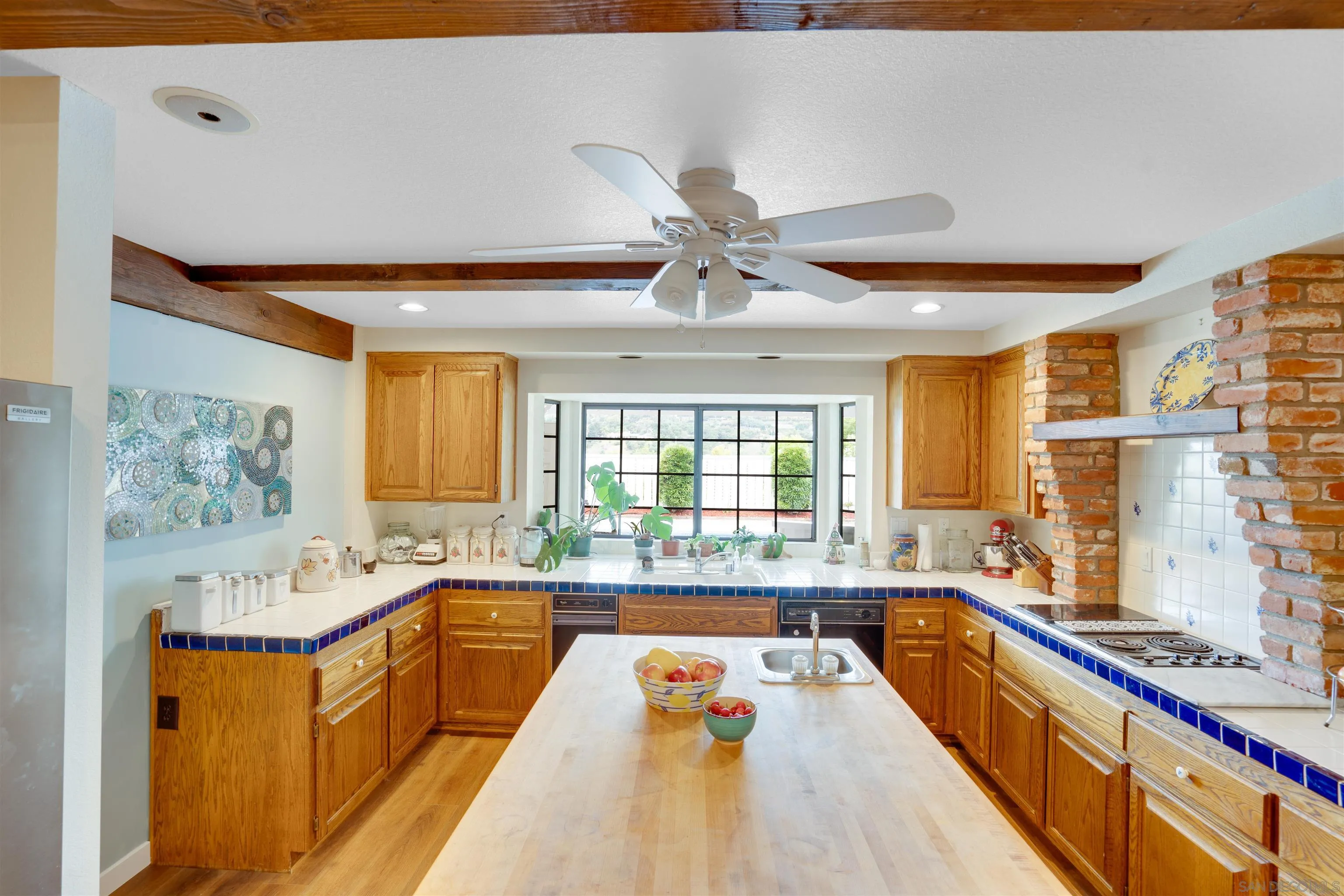 3675 Northcliff Drive Fallbrook, CA 92028 - Photo 13 of 37 a large kitchen with kitchen island a large window