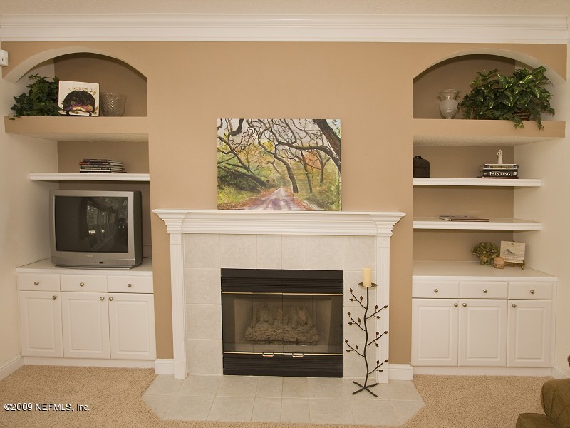 813 Mill Stream Road Ponte Vedra Beach, FL 32082 - Photo 11 of 22 a living room with white cabinets and fireplace