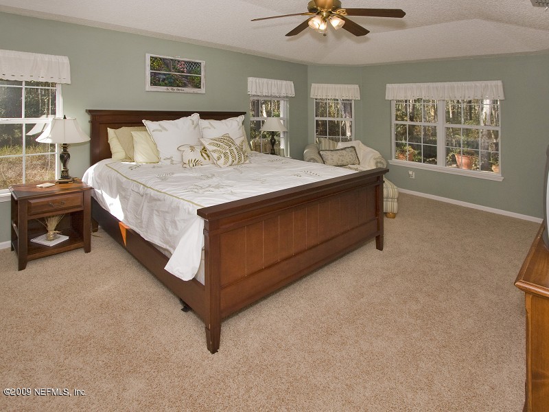 813 Mill Stream Road Ponte Vedra Beach, FL 32082 - Photo 13 of 22 a bed room with a bed and a couch