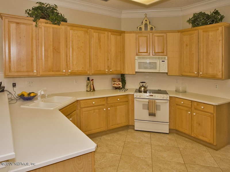 813 Mill Stream Road Ponte Vedra Beach, FL 32082 - Photo 8 of 22 a kitchen with a stove sink and cabinets