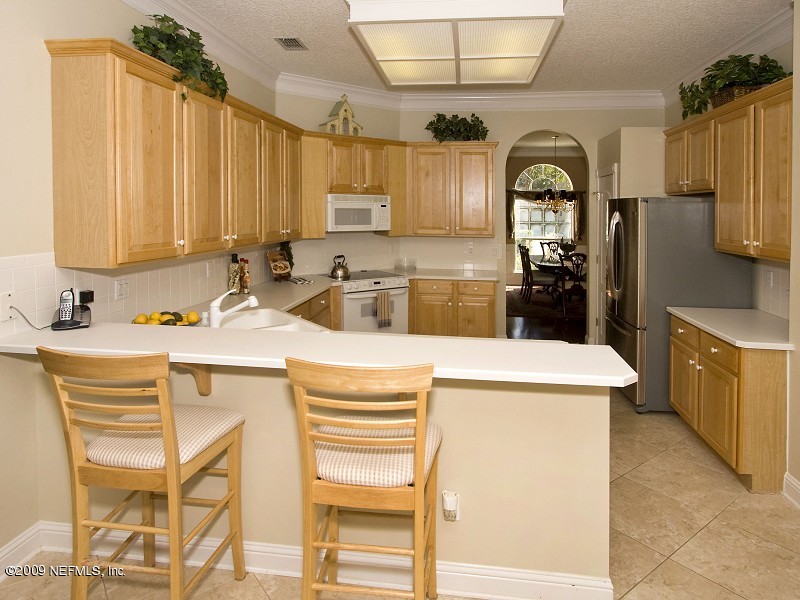 813 Mill Stream Road Ponte Vedra Beach, FL 32082 - Photo 9 of 22 a kitchen with a sink appliances and cabinets
