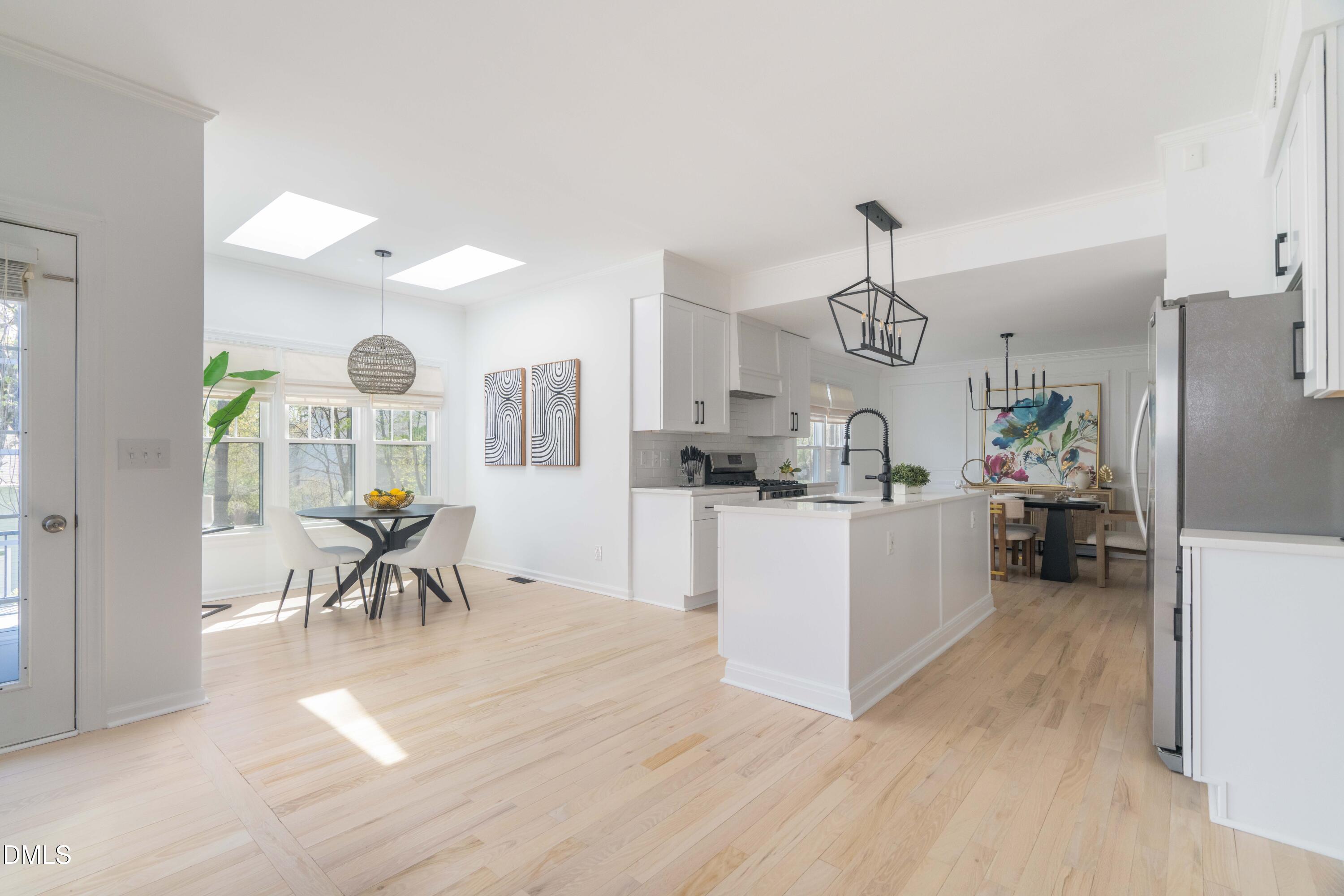 1512 Cooper Falls Lane Raleigh, NC 27614 - Photo 16 of 64 a kitchen with stainless steel appliances kitchen island granite countertop a table and chairs in it