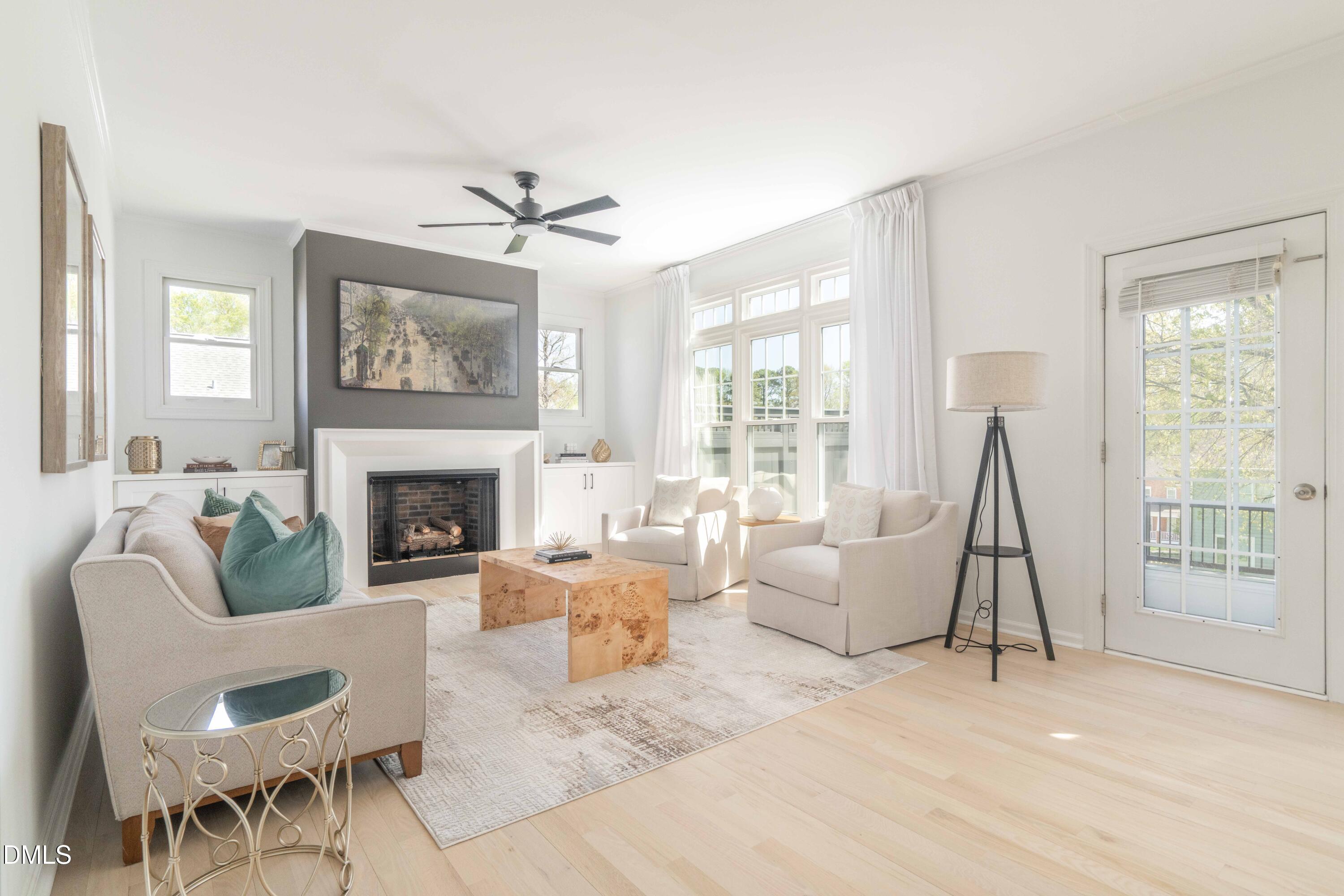 1512 Cooper Falls Lane Raleigh, NC 27614 - Photo 20 of 64 a living room with furniture a fireplace and a large window