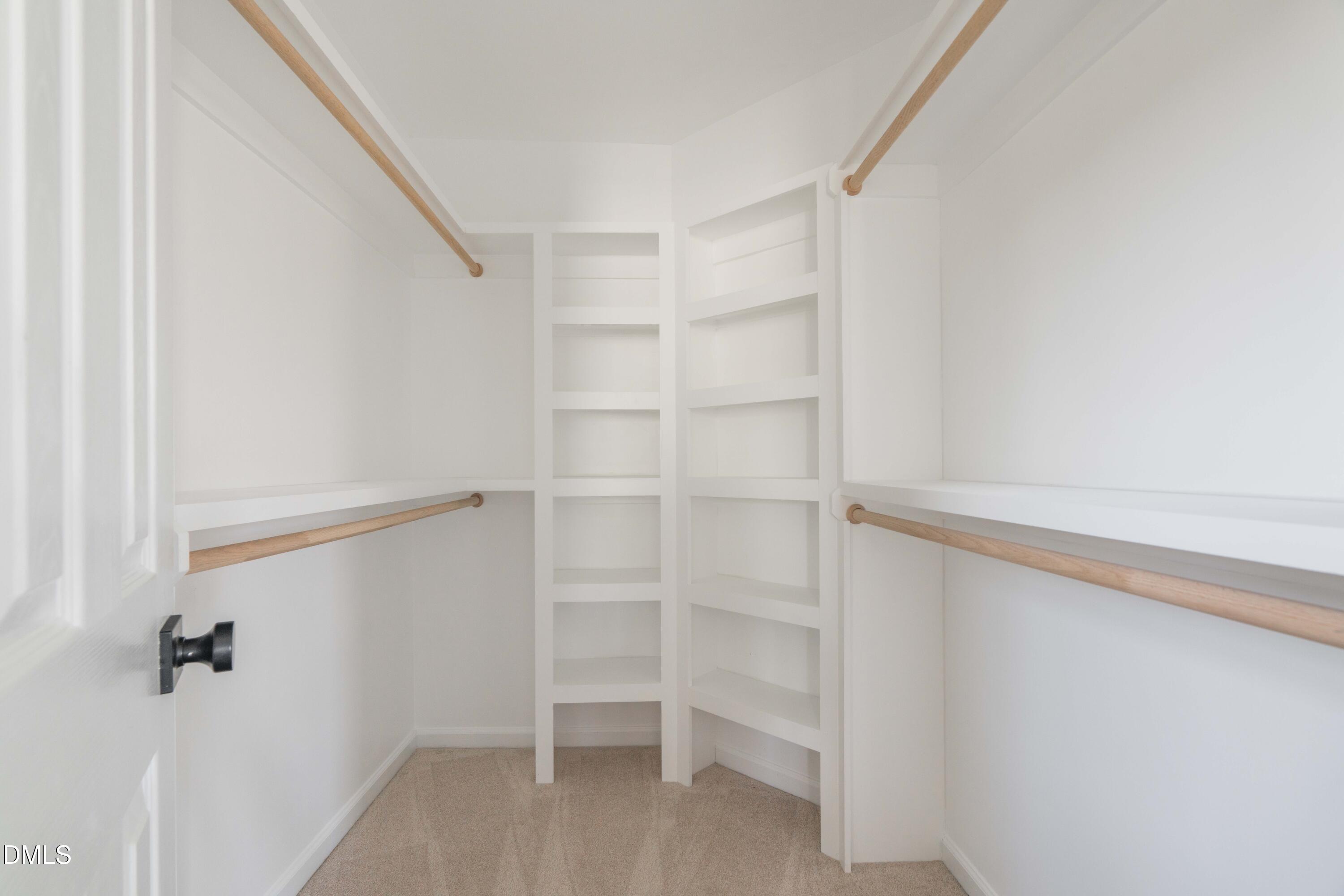 1512 Cooper Falls Lane Raleigh, NC 27614 - Photo 33 of 64 a view of walk in closet with empty racks
