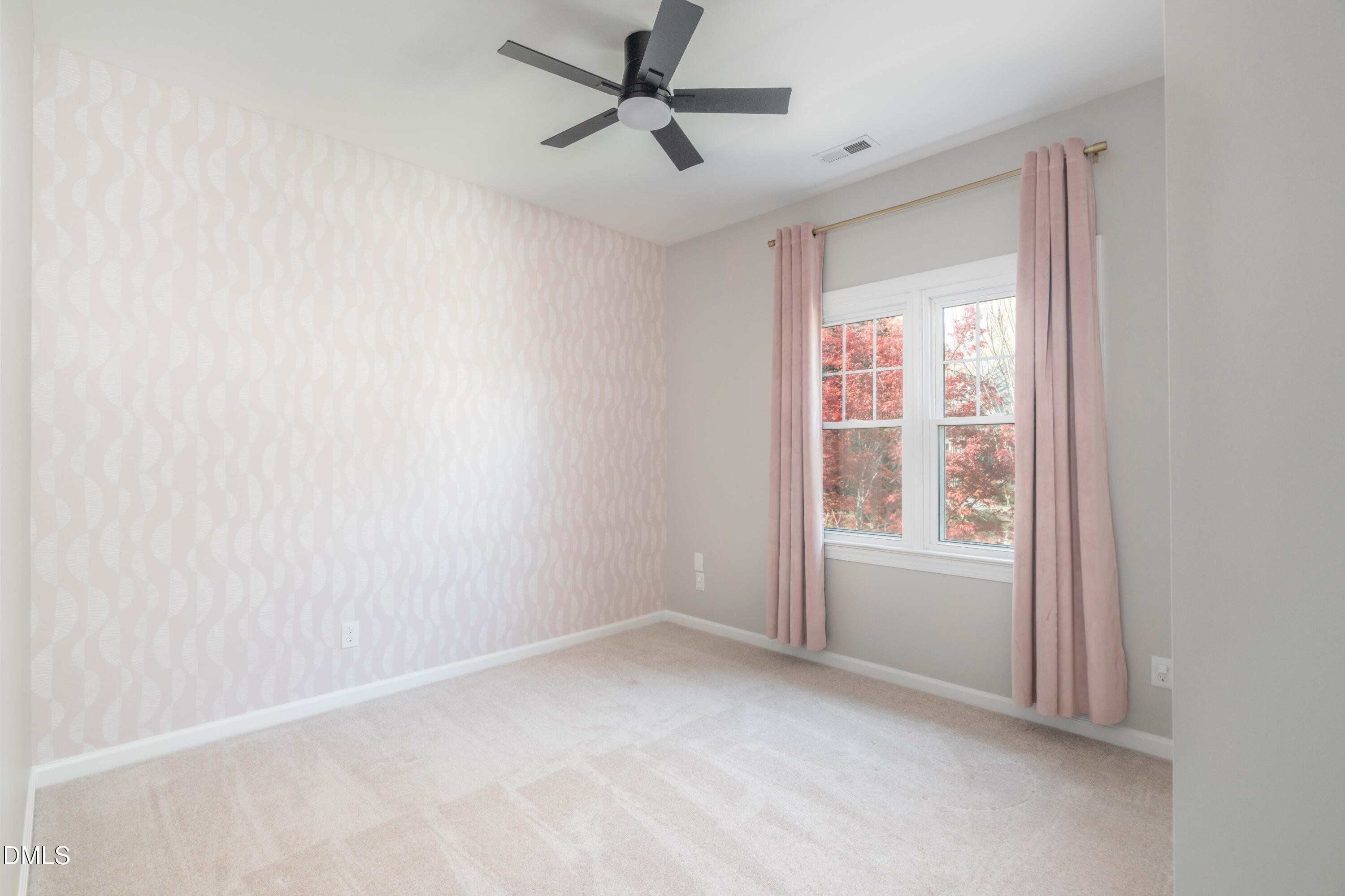 1512 Cooper Falls Lane Raleigh, NC 27614 - Photo 45 of 64 an empty room with a window and a fan