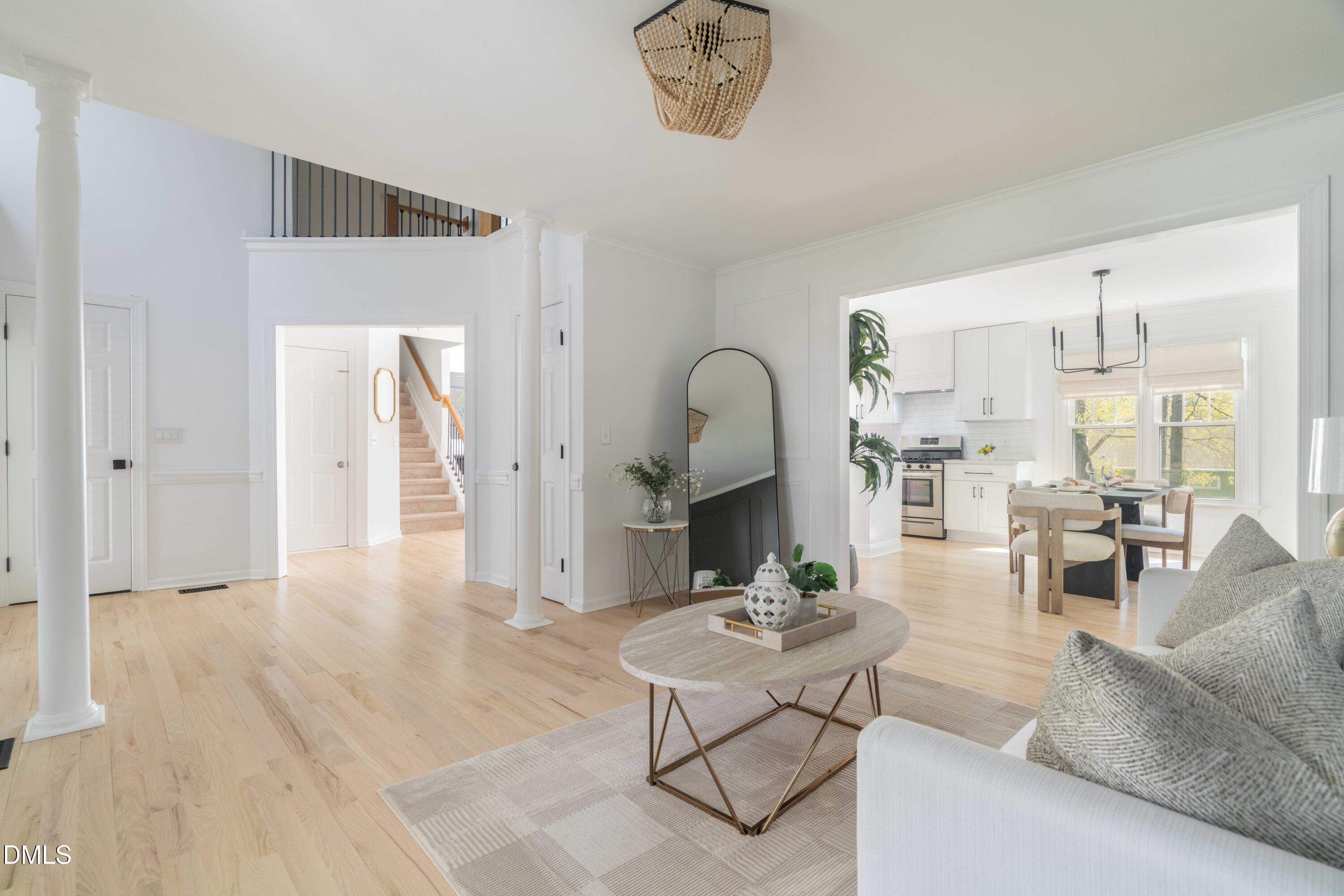 1512 Cooper Falls Lane Raleigh, NC 27614 - Photo 6 of 64 a living room with furniture a table and kitchen view