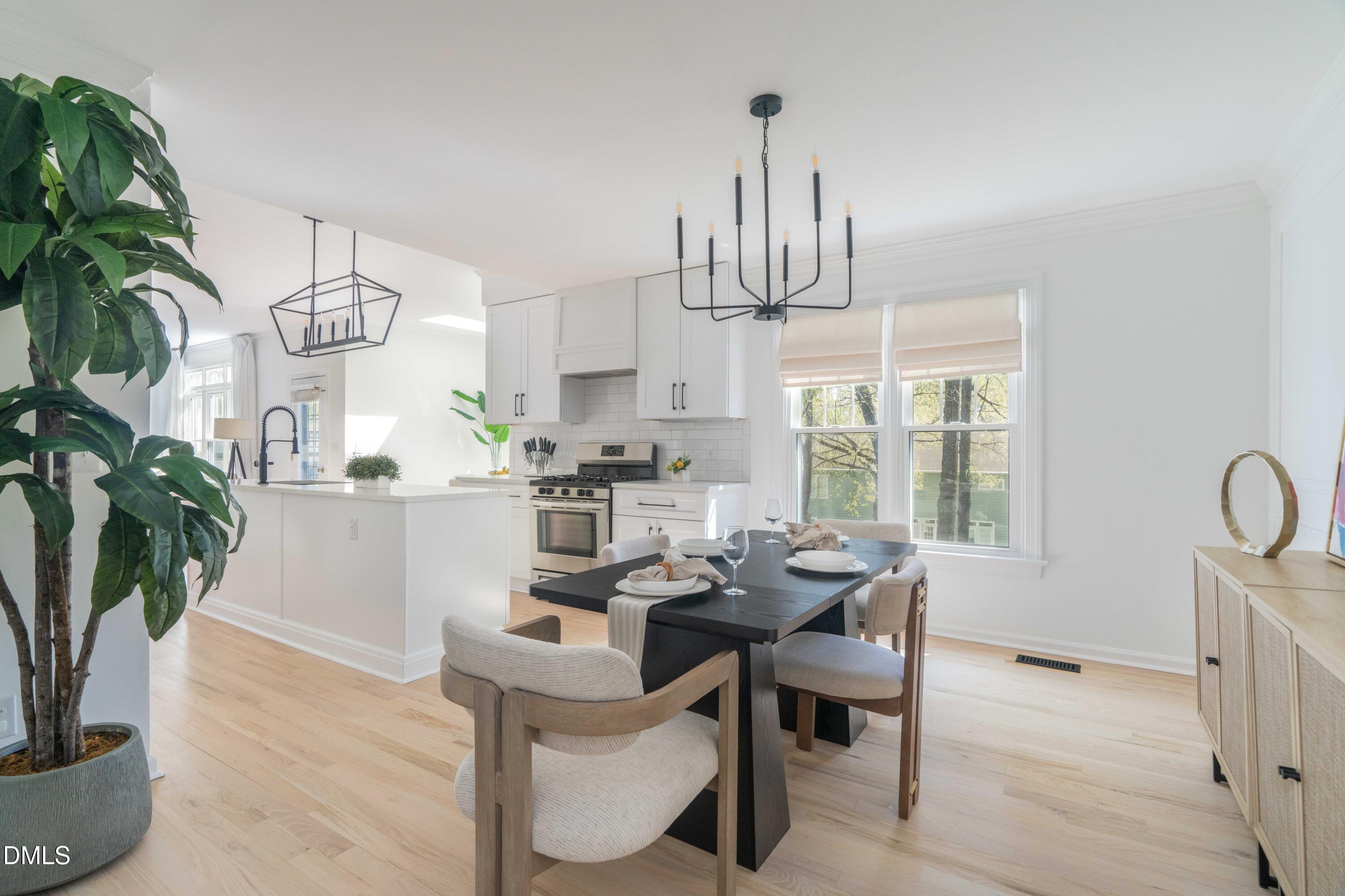 1512 Cooper Falls Lane Raleigh, NC 27614 - Photo 9 of 64 a view of a dining room with furniture window and wooden floor