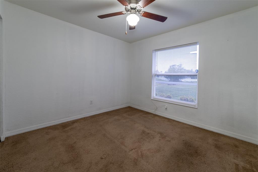 5107 Southwest 165th St Road Ocala, FL 34473 - Photo 25 of 34 an empty room with windows and fan