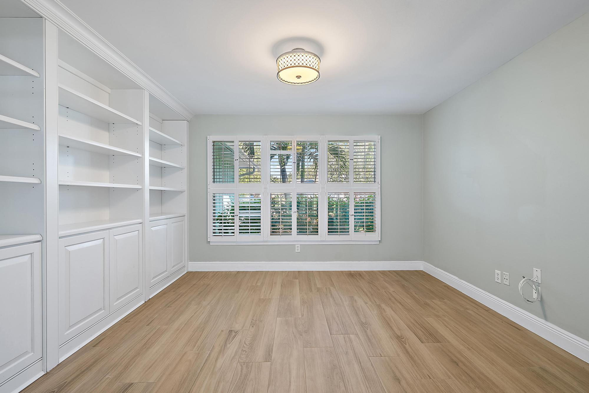 1260 Southwest 25th Lane Palm City, FL 34990 - Photo 11 of 37 a view of an empty room with a window and wooden floor