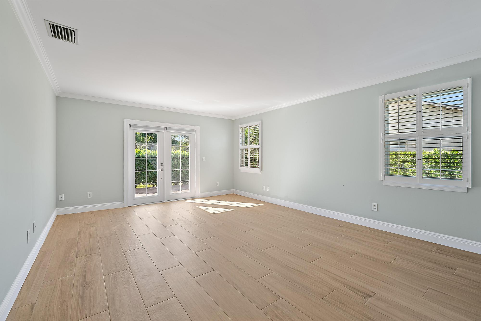 1260 Southwest 25th Lane Palm City, FL 34990 - Photo 13 of 37 a view of an empty room with wooden floor and a window