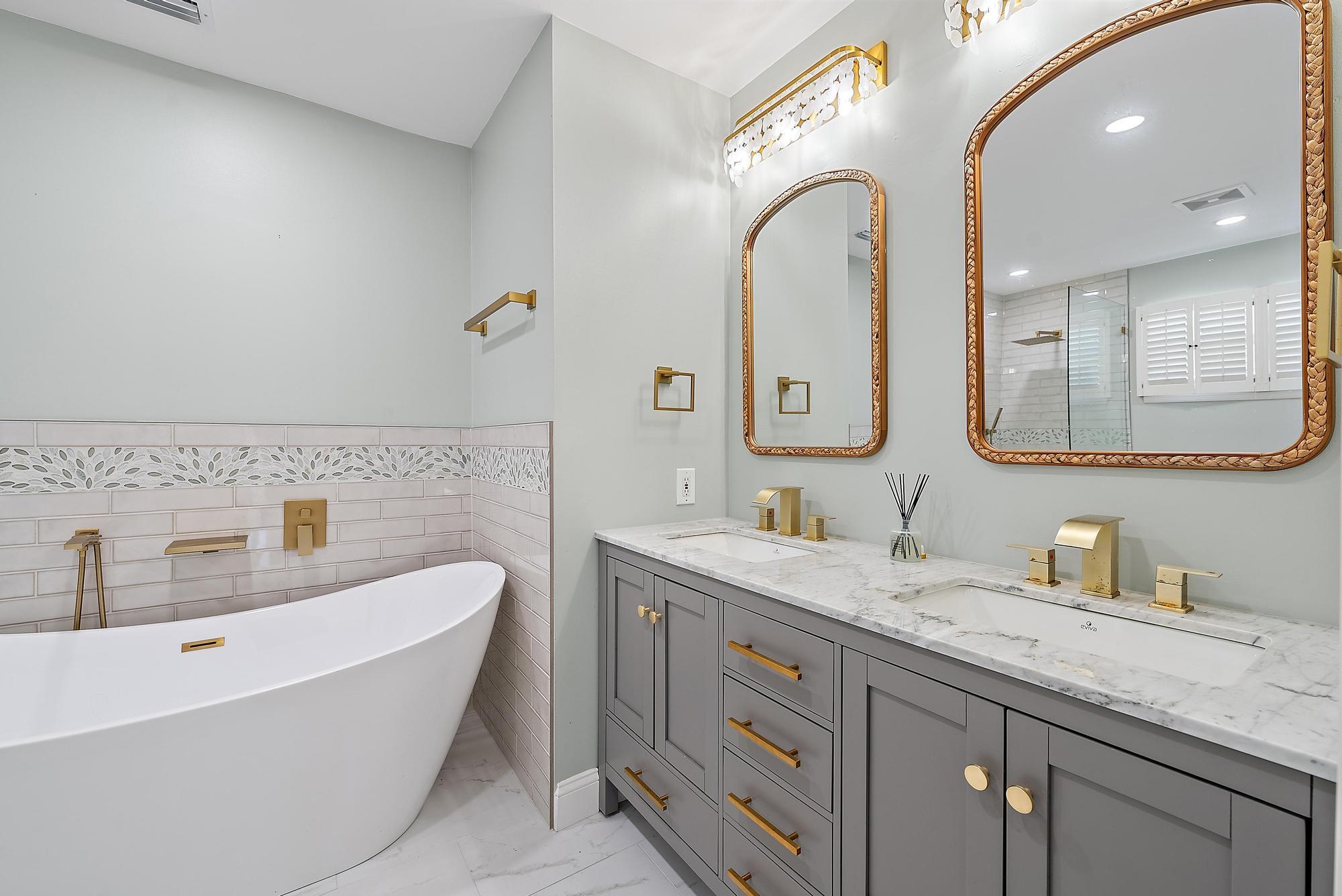 1260 Southwest 25th Lane Palm City, FL 34990 - Photo 16 of 37 a bathroom with a granite countertop sink mirror and bathtub