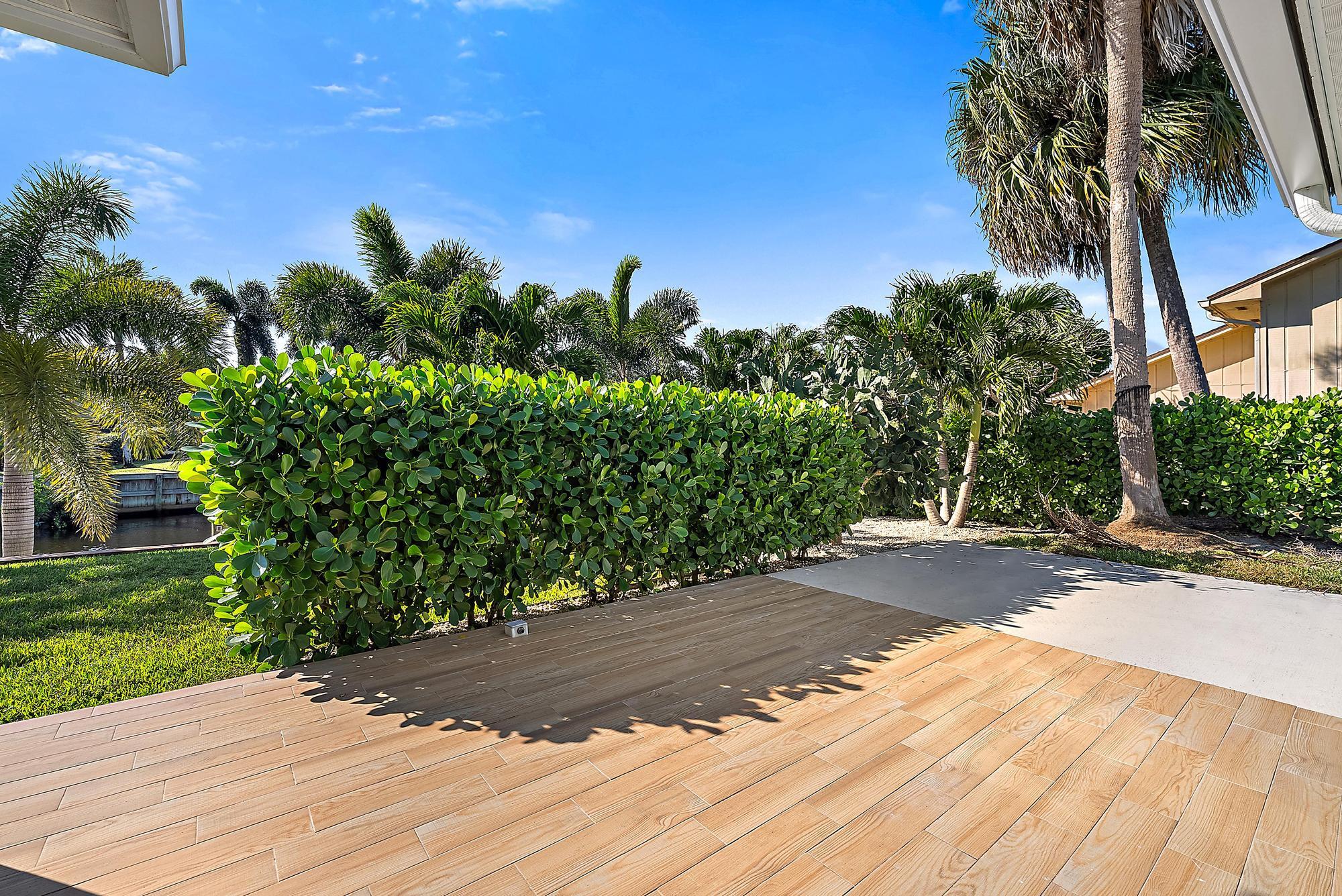 1260 Southwest 25th Lane Palm City, FL 34990 - Photo 27 of 37 a backyard of a house with lots of green space