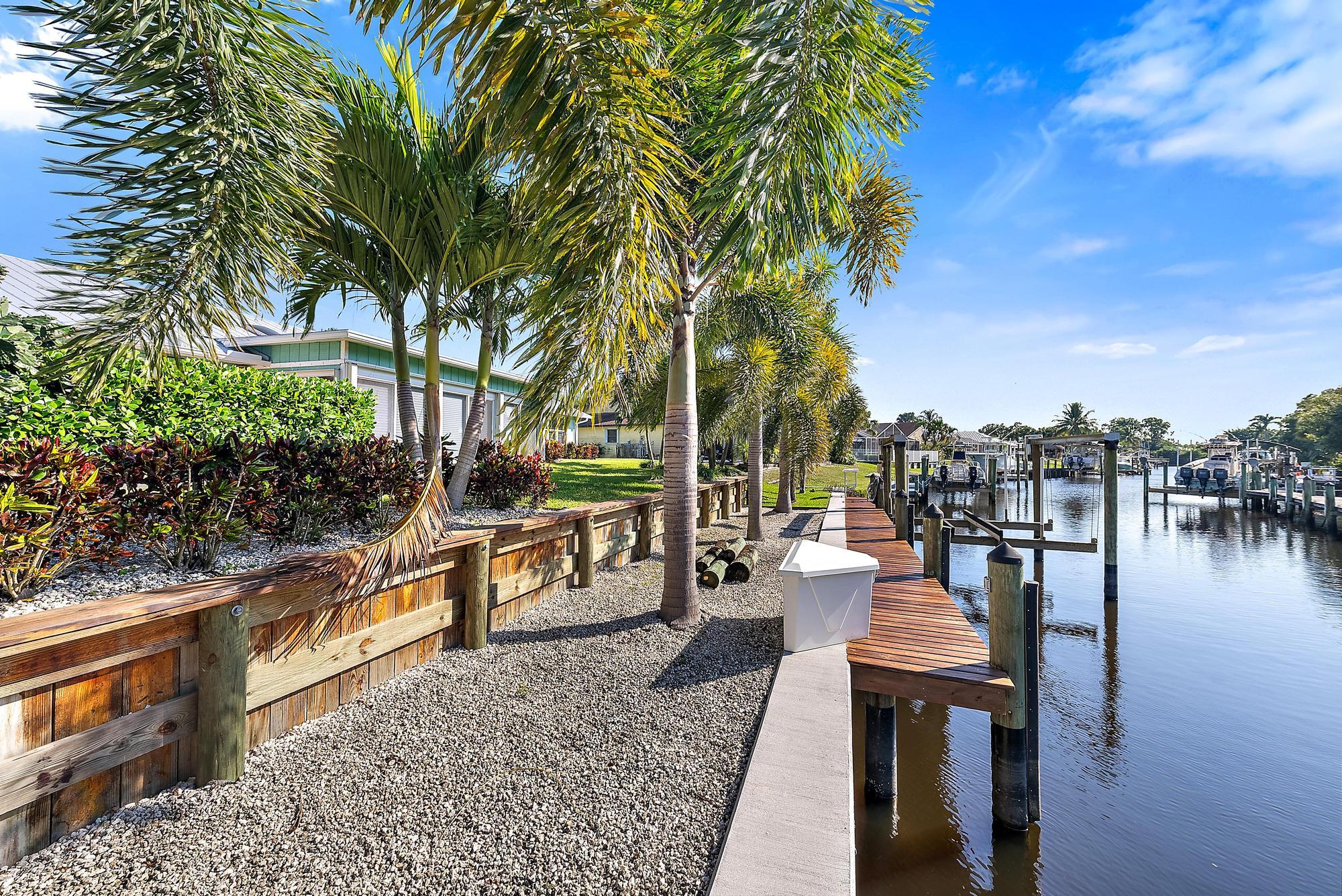 1260 Southwest 25th Lane Palm City, FL 34990 - Photo 28 of 37 a view of a lake with couches and wooden floor