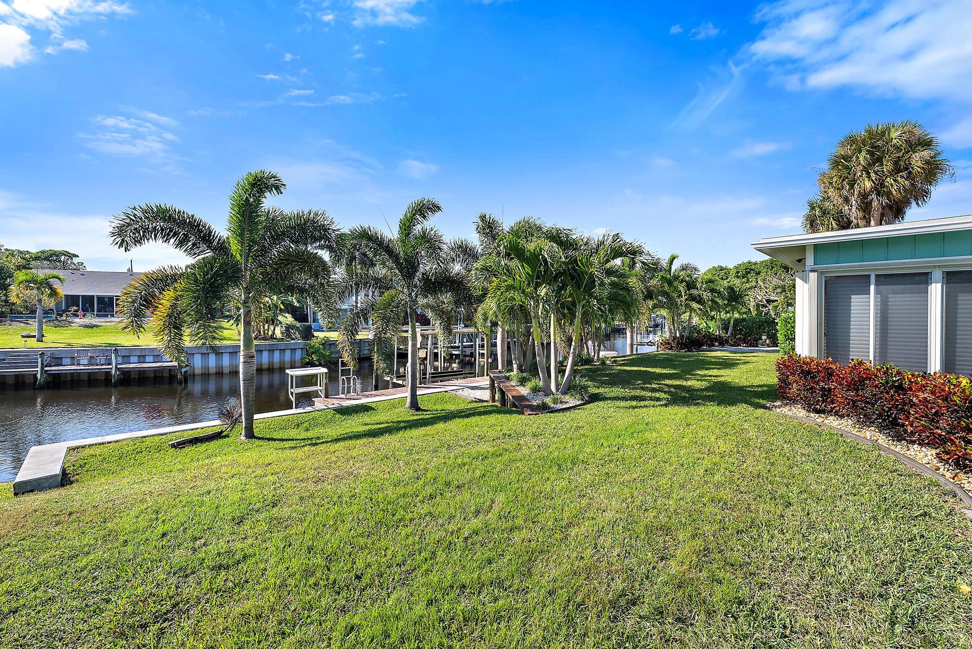 1260 Southwest 25th Lane Palm City, FL 34990 - Photo 30 of 37 a view of a house with a backyard porch and sitting area