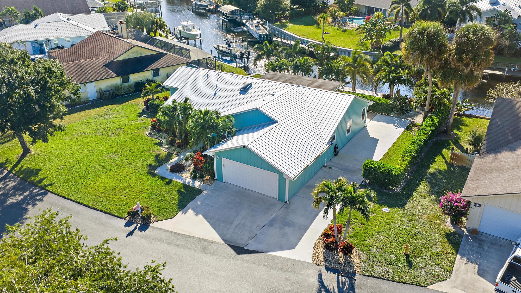 1260 Southwest 25th Lane Palm City, FL 34990 - Photo 34 of 37 an aerial view of a house with a garden and swimming pool