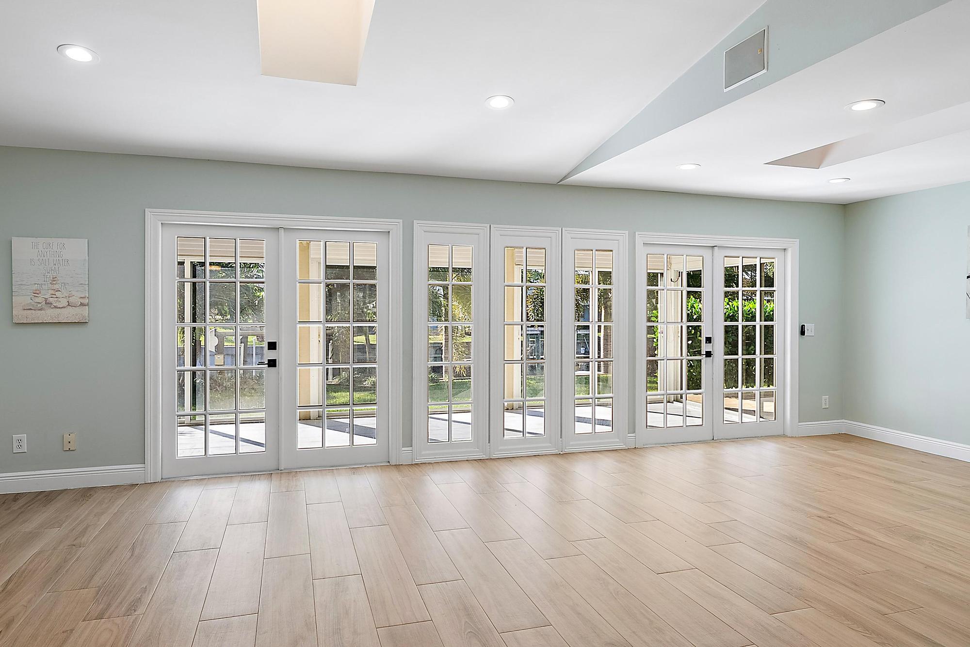 1260 Southwest 25th Lane Palm City, FL 34990 - Photo 6 of 37 a view of an empty room with wooden floor and a window