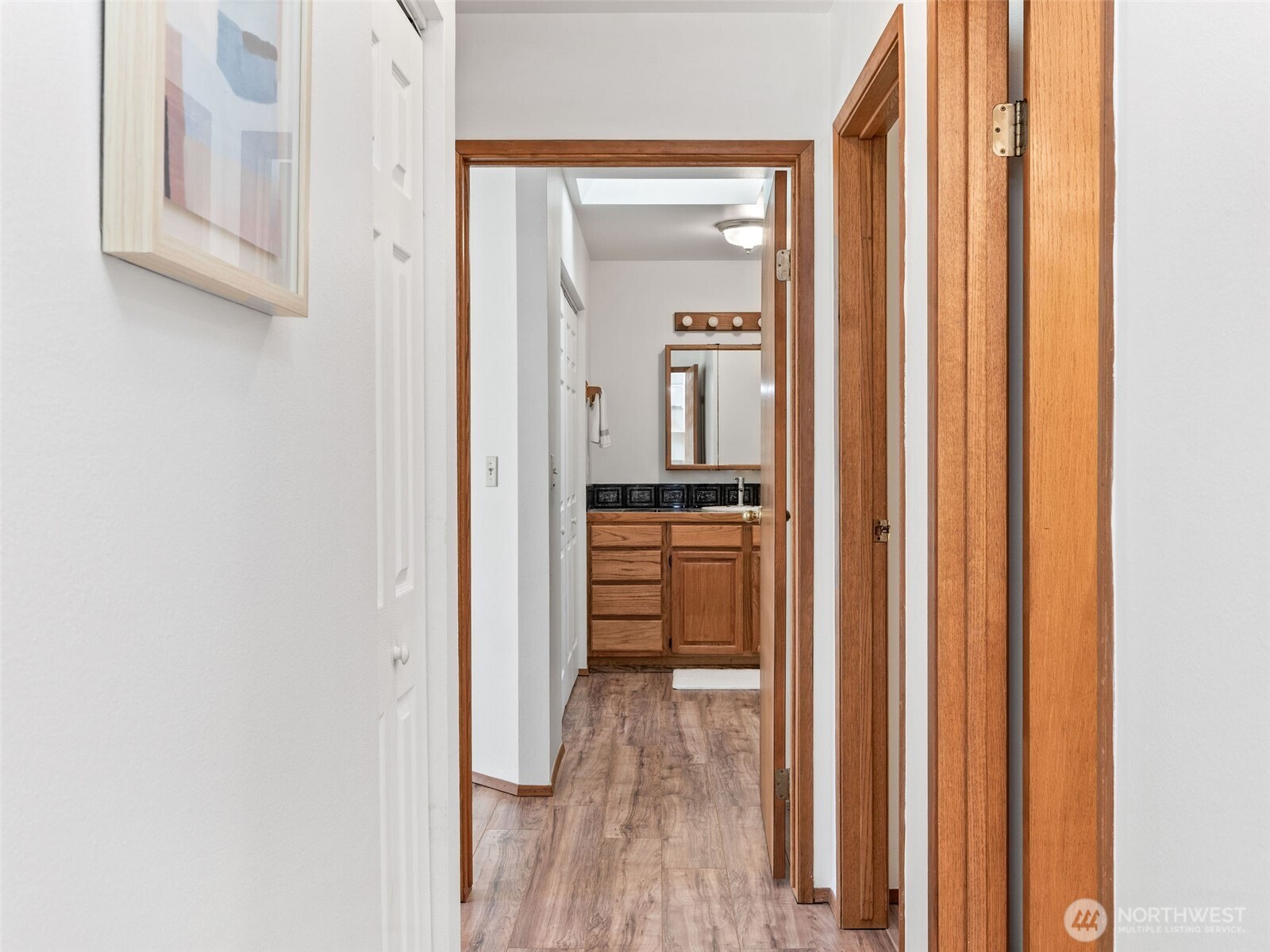 919 43rd Street Port Townsend, WA 98368 - Photo 11 of 28 a view of a hallway with wooden floor and a kitchen space