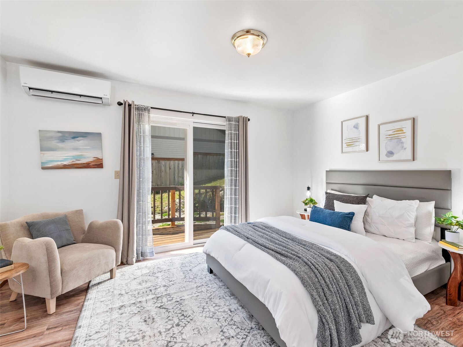 919 43rd Street Port Townsend, WA 98368 - Photo 12 of 28 a bedroom with a balcony a large bed and a couch