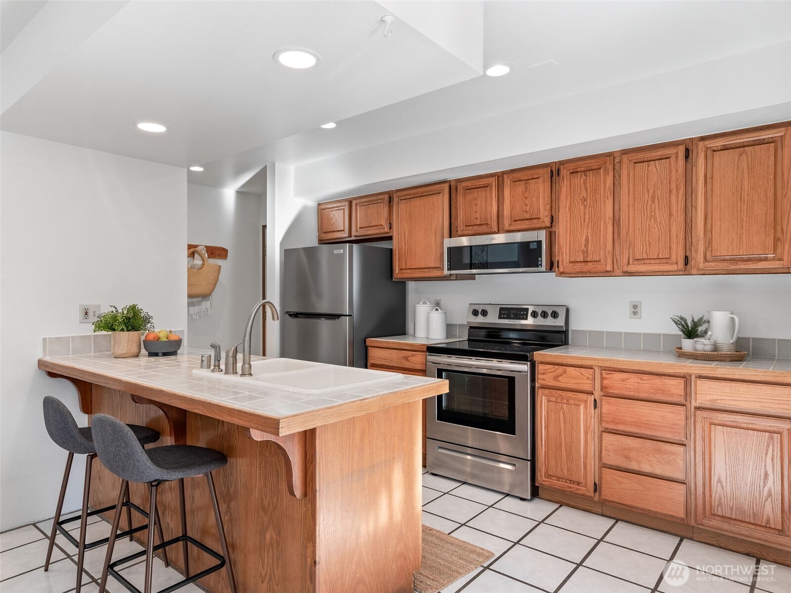 919 43rd Street Port Townsend, WA 98368 - Photo 8 of 28 a kitchen with stainless steel appliances granite countertop a stove refrigerator sink and cabinets