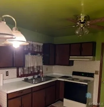 a kitchen with a sink a stove and cabinets