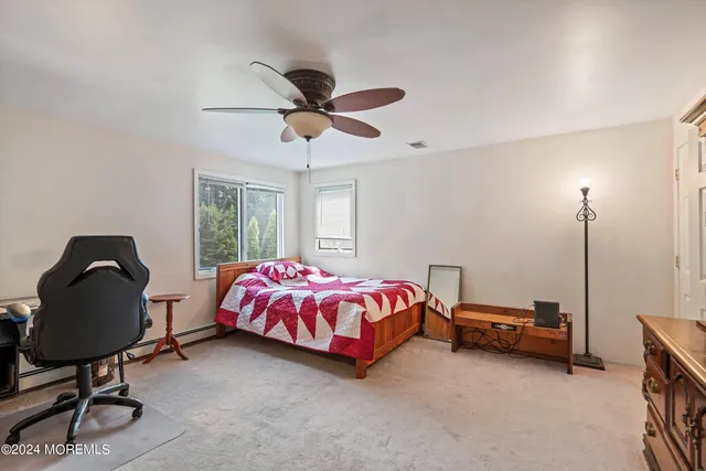 a spacious bedroom with a bed a chandelier and a window