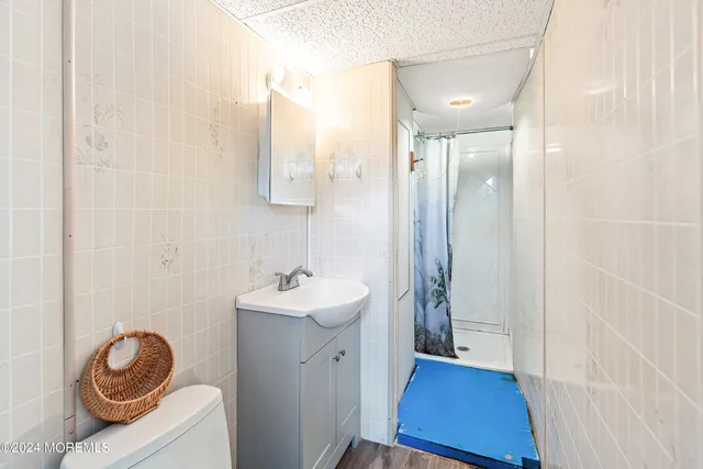 a bathroom with a sink a toilet and a mirror