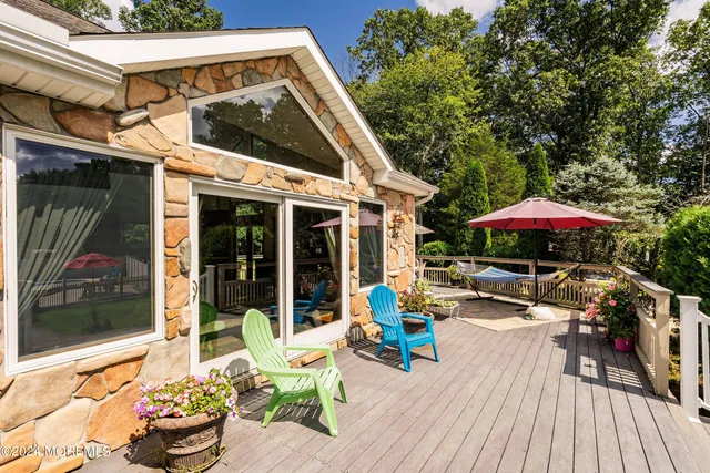 a view of a patio with table and chairs potted plants with wooden floor