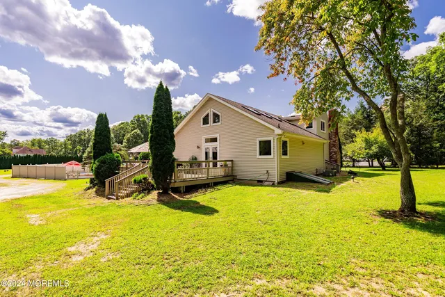 a view of a house with swimming pool and sitting area