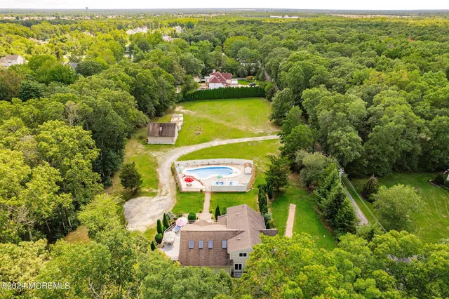 an aerial view of residential houses with outdoor space and swimming pool