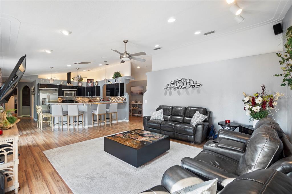 26650 Pelican Street Eustis, FL 32736 - Photo 26 of 69 a living room with lots of furniture and view of kitchen