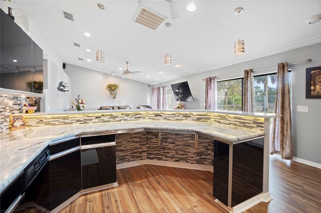 26650 Pelican Street Eustis, FL 32736 - Photo 9 of 69 a large kitchen with stainless steel appliances granite countertop a stove and a refrigerator