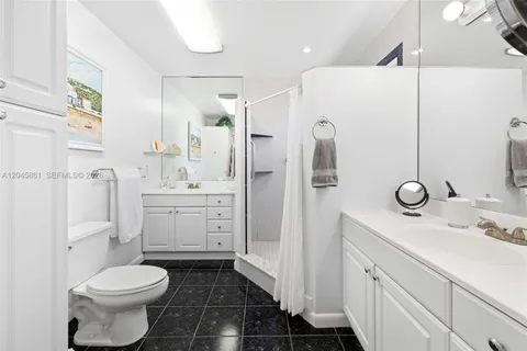 a bathroom with a sink toilet vanity and shower
