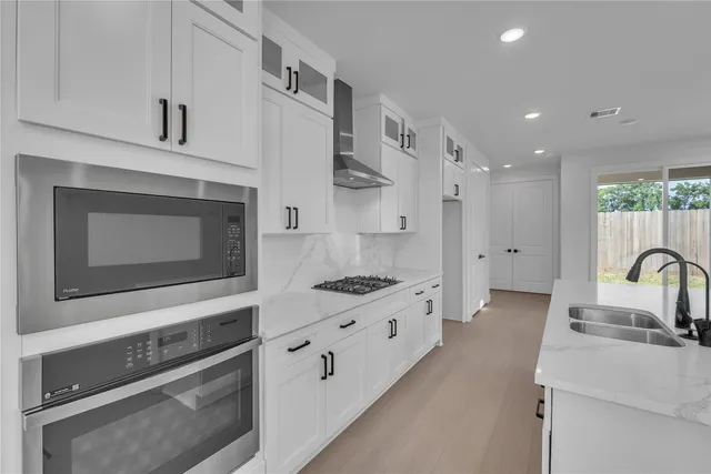 a kitchen with a sink and natural light