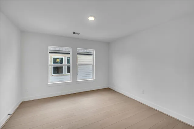 a view of a house with a yard and wooden fence