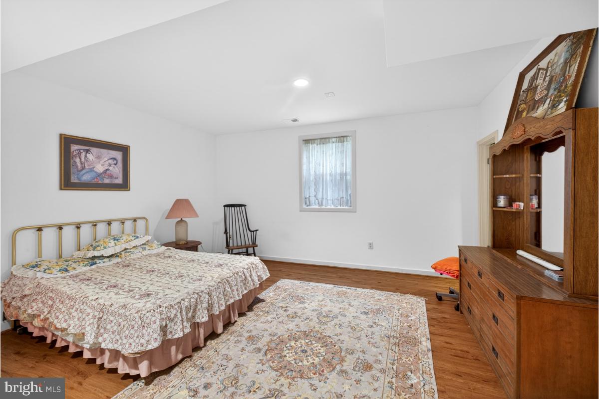 10320 Glen Road Potomac, MD 20854 - Photo 22 of 75 a bedroom with a bed and a flat screen tv