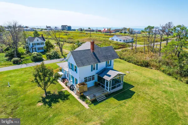 an aerial view of a house with a garden and lake view