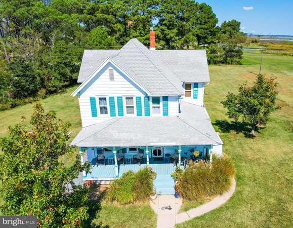 a aerial view of a house with a yard table and chairs