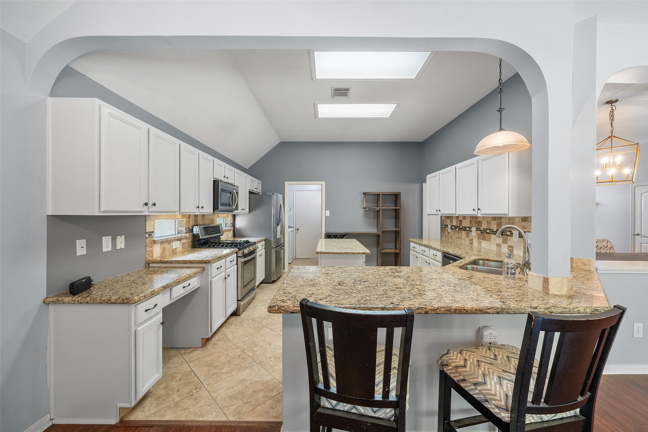 19718 Teller Boulevard Spring, TX 77388 - Photo 15 of 47 a kitchen with granite countertop kitchen island a table and chairs in it