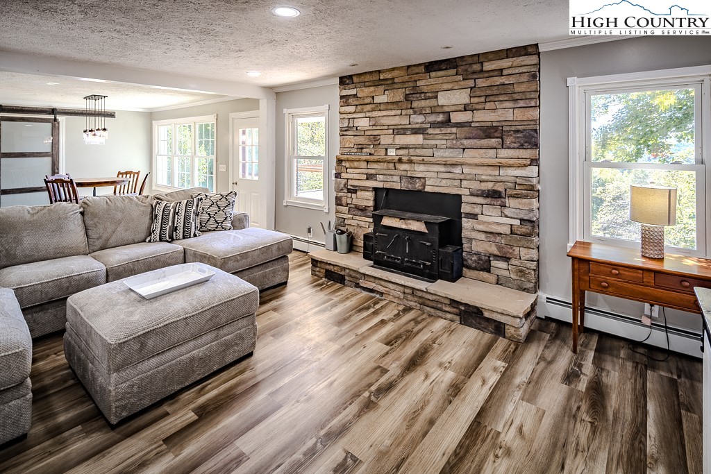 640 Fairview Heights Boone, NC 28607 - Photo 11 of 50 a living room with furniture a large window and a fireplace