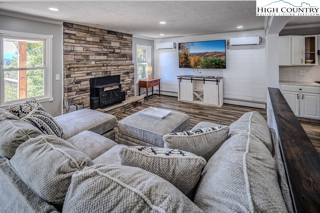 640 Fairview Heights Boone, NC 28607 - Photo 16 of 50 a living room with furniture a flat screen tv and a fireplace