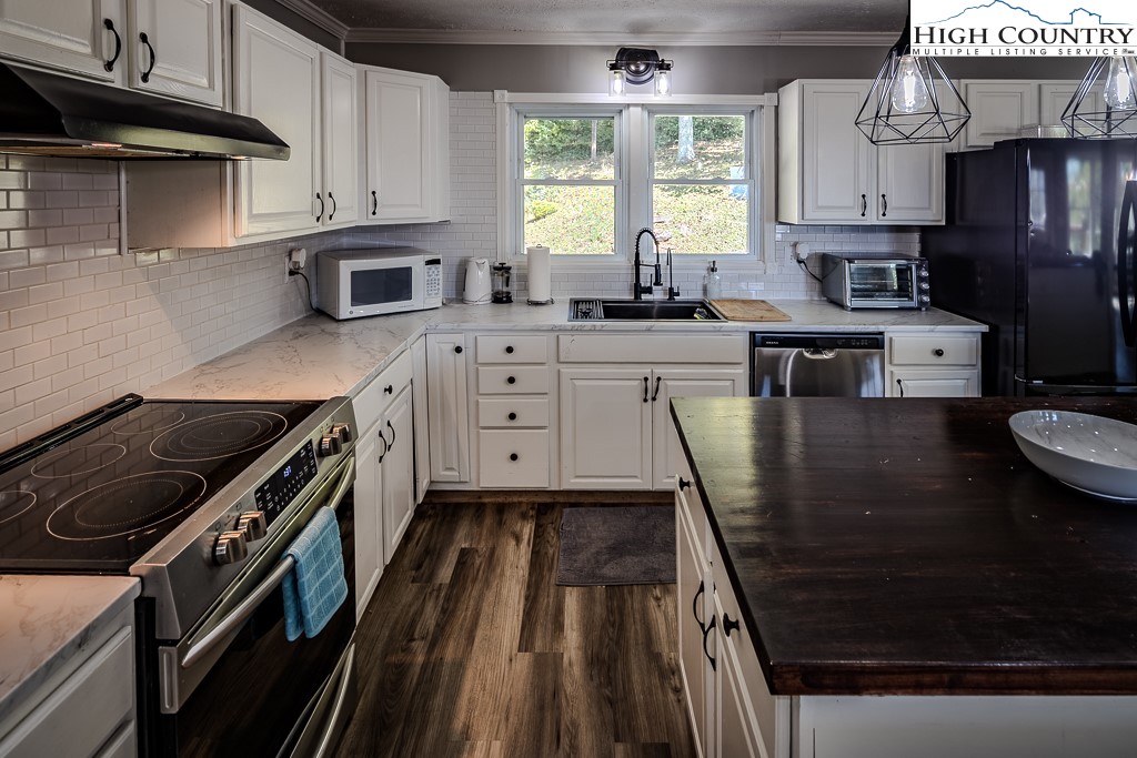 640 Fairview Heights Boone, NC 28607 - Photo 20 of 50 a kitchen with wooden cabinets and a stove top oven