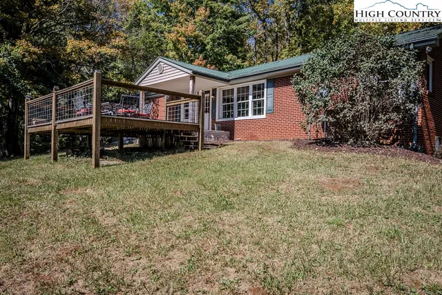 an aerial view of a houses with a yard