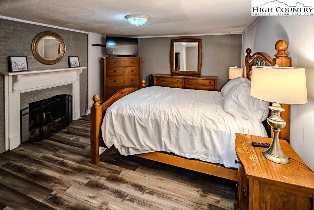 640 Fairview Heights Boone, NC 28607 - Photo 37 of 50 a bedroom with a bed and a fireplace