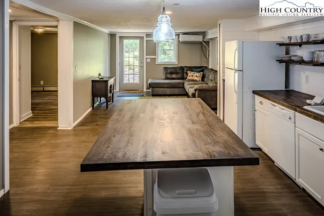 a kitchen with kitchen island a stove a sink dishwasher and a refrigerator