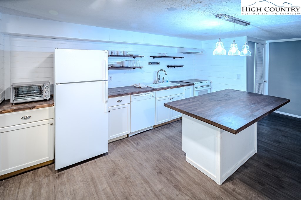 640 Fairview Heights Boone, NC 28607 - Photo 40 of 50 a kitchen with granite countertop a stove a sink and a refrigerator